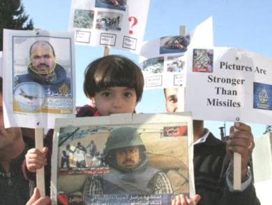 ابنة طارق ايوب تحمل صور والدها المراسل لدى الجزيرة الذي قتل في العراق عام2003