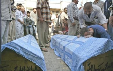 عراقي يبكي فوق جثمان احد القتلى يوم امس