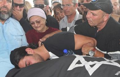 اسرائيلي يقبل احد اقاربه الذي قتل في الهجوم الانتحاري