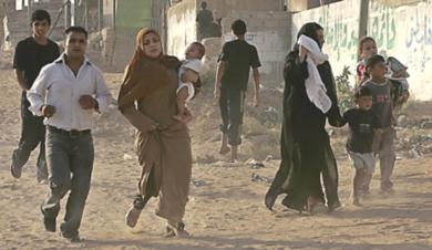 فلسطينيون يركضون للهرب من القصف الاسرائيلي 