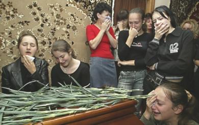 صورة من الأرشيف لعائلات الضحايا في لحظة حزن بعد مقتل اكثر من 223 معظمهم من الاطفال