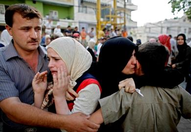 عائلة فلسطينية يبكون بعد اشتداد المعارك في المخيم