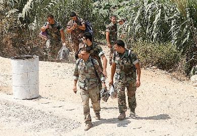 جنود لبنانيون يستعدون للراحة بعد اجلاء عائلات المسلحين