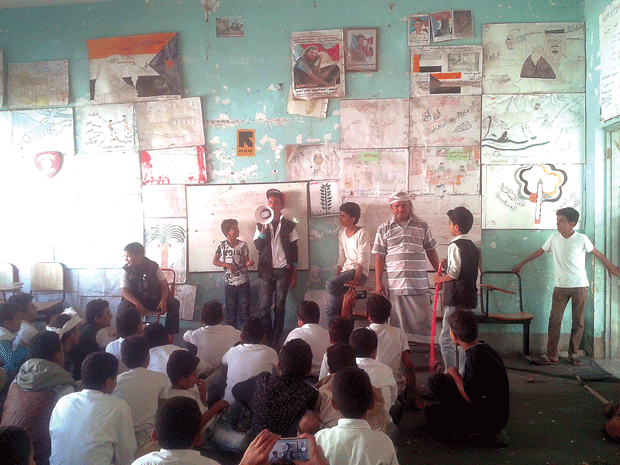 صورة لطلاب في إحدى القاعات الدراسية وهم ينفذون نشاط إبداعي بإشراف معلمهم 