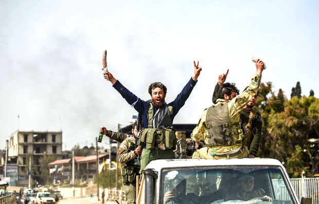 مقاتلون سوريون مدعومون من تركيا يحتفلون بانتصارهم على الأكراد في مدنية عفرين أمس