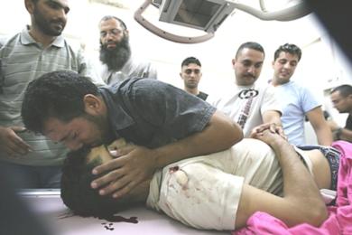 فلسطيني يقبل رأس الشهيد عميد المصري