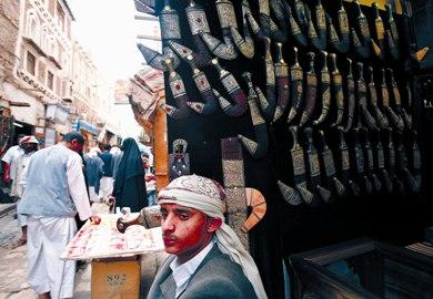 يمني يقف خارج متجره لبيع (الجنابي) في سوق الملح بصنعاء