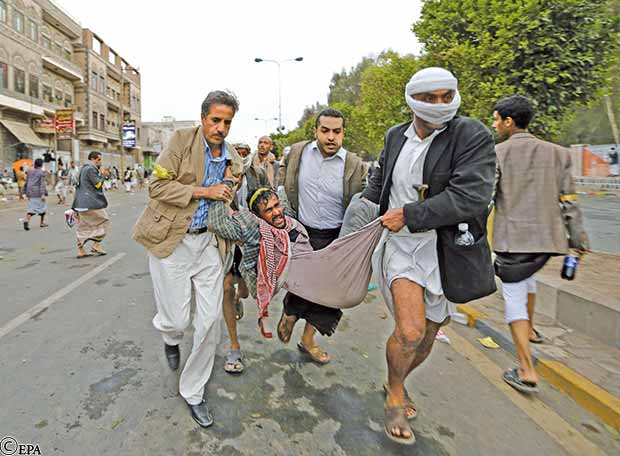 وجريح آخر يتم نقله بعيدا عن موقع المصادمات 