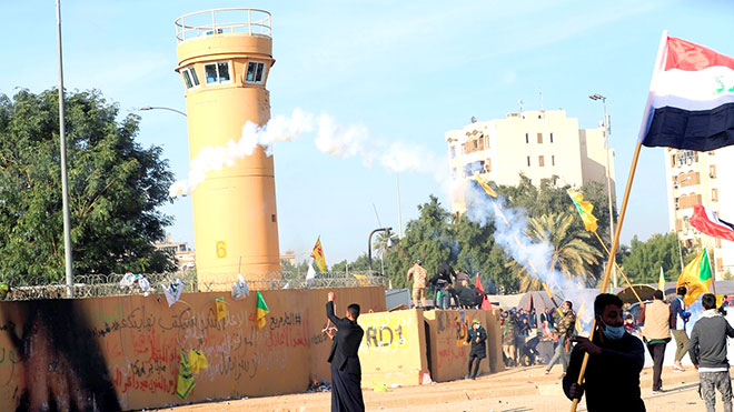 إطلاق غاز مسيل للدموع على متظاهرين أحرقوا الأعلام الأميركية أمام سفارة واشنطن في بغداد إطلاق غاز مسيل للدموع على متظاهرين أحرقوا الأعلام الأميركية أمام سفارة واشنطن في بغداد